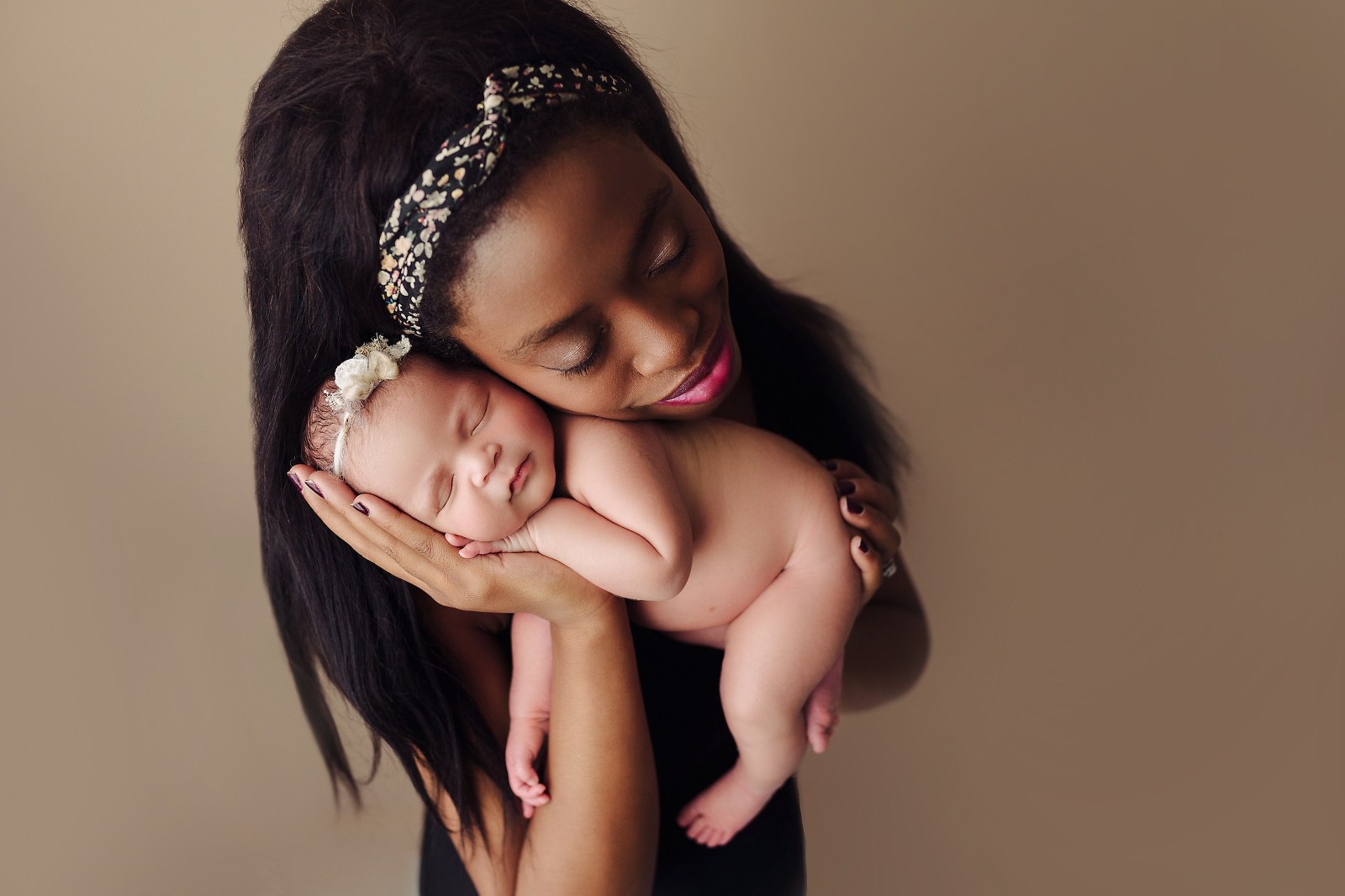 In-Studio Newborn Photography mother holding baby