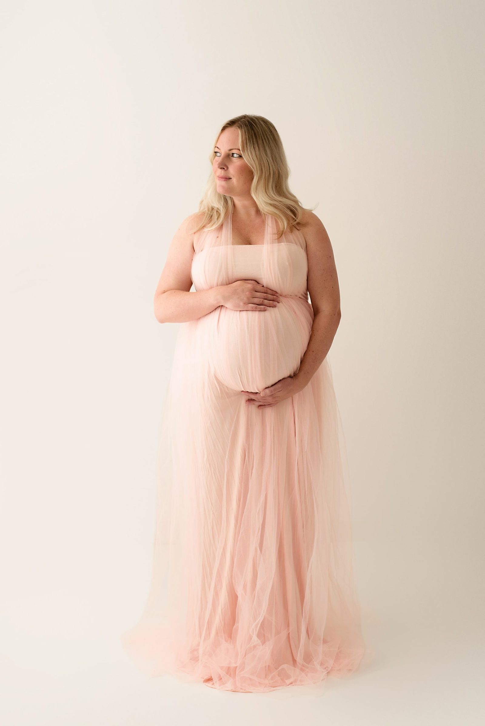 in-studio maternity photoshoot pink dress